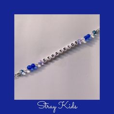 a blue and white beaded bracelet with the words staykids written on it