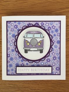 a purple and white card with an image of a vw bus in the center