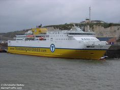 a large white and yellow boat in the water