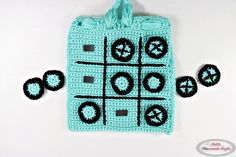 a crocheted tic - tac - toe board with buttons