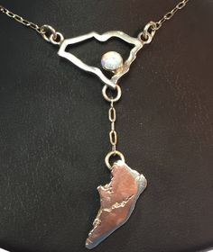 South Carolina  in 16 gauge sterling silver with a Hilton Head Island Charm dangling.  Add a birthstone of your choice.  This piece features a fire opal and stone.  Any state, any birthstone can be produced.  This is a custom order and one of a kind.   Also available without the island charm dangle for $139.00 Comes in a new box and hand embroidered gift bag. Hand Embroidered Gifts, Embroidered Gifts, Hilton Head Island, Hilton Head, Fire Opal, Jewelry Making Supplies, South Carolina, Sterling Silver Bracelets, Silver Bracelet