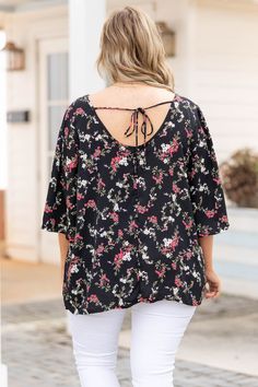 The love we have for this top is rare and special! We love the neutral black color that can be paired with so many bottoms! The floral pattern is perfect for warm weather and the open tie back is so chic! Style this with some white skinnies and your best wedges for a stylish look! 100% Polyester Black Tie-back Top For Beach, Black Floral Print Vacation Blouse, Black V-neck Top With Tie Back, Summer Black Blouse For Day Out, Black Summer Blouse For Day Out, Black Casual Tops With Tie Back, Casual Black Tops With Tie Back, Black Tie Back Top For Day Out, White Skinnies