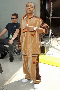 a man in a brown and orange outfit