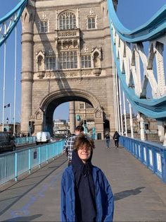 a man standing in front of the tower bridge