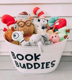 a bucket filled with stuffed animals sitting on top of a porch