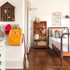 a child's room with a bed, bookcase and toys