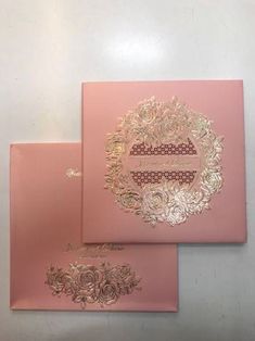 two pink cards with gold foil on them