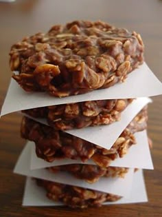 three granola cookies stacked on top of each other with white paper sticking out of them