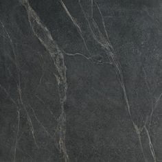 a black marble textured surface with grey veining