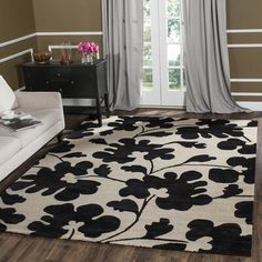 a black and white rug with flowers on it