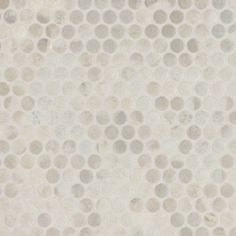 a white and grey tile with circles on it