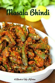 masala bhindi in a white bowl on a wooden table