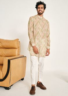 The cream and green gul malai cotton kurta pajama set is constructed with a soft, lightweight fabric. The floral butis printed within a geometric outline is reminiscent of palatial marble interiors. While the pattern dates back centuries, it remains timeless. This shirt style kurta comes with cuffed sleeves, a mandarin collar, two hip pockets on each side and has an angular hemline. The kurta is not lined. This is a 2 piece set complete with a cream trouser style cotton pajama. The trouser style Geometric Outline, Cream Trousers, Kurta Pajama, Nehru Jackets, Cotton Kurta, Western Wedding, Trouser Style, Wedding Service, The Cream