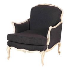 a black and white chair with gold trim