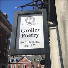 a sign hanging from the side of a building advertising a book shop in new york