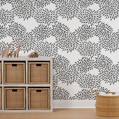 the wallpaper in this room is decorated with black and white flowers, which are accented with wicker baskets