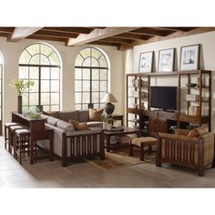 a living room filled with furniture and windows