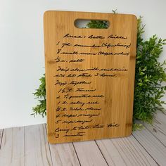 a wooden cutting board with writing on it