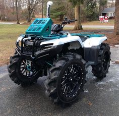 a white and blue four - wheeler parked on the street