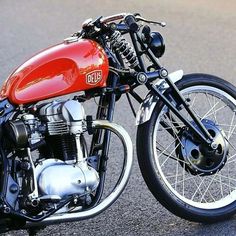 a red and black motorcycle parked on the street