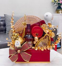 a red box filled with assorted items on top of a white marble countertop