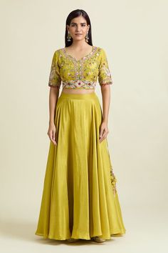 Yellow can can attached lehenga in a solid flowy base. Comes with nakshi thread embroidered jacket floral paisley motifs, embellished by sequins and beads. Paired with a padded embroidered blouse. - Aza Fashions Silk Sets For Navratri Reception, Silk Sets For Reception And Navratri, Silk Sets For Reception At Navratri Festival, Silk Set With Zari Work And Long Skirt, Silk Long Skirt Set With Zari Work, Silk Sets For Reception In Transitional Season, Silk Long Skirt Set For Diwali, Pista Green Gown With Cutdana, Pista Green Gown With Cutdana Detailing