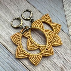 a pair of scissors are sitting on a wooden table next to an embroidered keychain