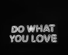 a neon sign that says do what you love in white letters on a black background