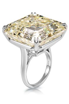 a yellow diamond ring on a white background