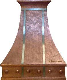 a copper colored stove hood with blue trim