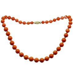 This rare vintage necklace is composed of genuine coral beads forming a graduated strand and ranging in size from 7.50mm to 12.00mm. Completed with a 14k yellow gold clasp accented by a single-cut diamond. Made in Italy circa 1980s. Measurements: 0.98" (25mm) width, 17.75" (45cm) length. Total weight 57.50gram. Classic Orange Necklace For Formal Occasions, Classic Orange Necklaces For Formal Occasions, Orange Classic Formal Necklaces, Orange Classic Formal Necklace, Classic Orange Round Necklace, Cream Necklace, Diamond Ball, Coral Beads Necklace, Rose Gold Pearl