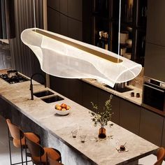 a modern kitchen with marble counter tops and chairs