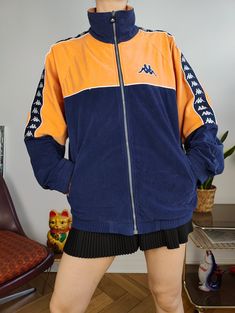 DESCRIPTION Vintage Kappa track jacket in velour fabric in navy blue and orange.  CONDITION This vintage jacket is in great vintage condition SIZING This vintage jacket is labelled as size men M and estimated as size M-L > Please check measurements below as all vintage sizes are different Measurements: Arms from sleeve till neck seam: 79cm Armpit to armpit: 56cm Back: 72cm Model is size XS/S and is 1m65 MATERIAL 100% polyester WITH LOVE  All vintage fashion for women are washed and shipped from Alix Earle, Sport Jacket, Velour Fabric, Vintage Clothing Online, Summer Sports, Sports Jacket, Mode Vintage, Vintage Pieces, Track Jacket