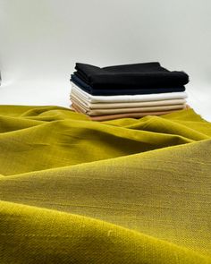 three different colors of fabric sitting on top of each other