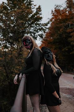 two women dressed in black standing next to each other