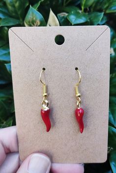 1 pair cute tiny red chili pepper earrings. Please note these charms are small and refer to photo for size. Ear wires are gold plated stainless steel which are tarnish resistant and hypoallergenic. Please note they do contain a small percentage of nickel. If you have a nickel allergy, please leave me a note and I will use ear wires that do not contain nickel; however, the wires without nickel are not tarnish resistant. Pepper Necklace, Chili Pepper Earrings, Novelty Red Jewelry With Charms, Novelty Red Pierced Earrings, Red Whimsical Nickel-free Earrings, Nickel Allergy, Red Chili Peppers, Red Chili, Food Jewelry