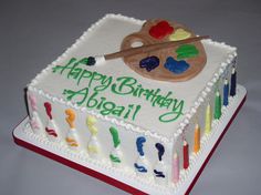 a birthday cake with an artist's palette on it