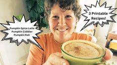 a woman holding up a cup filled with pumpkin spice latte