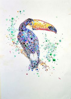 a colorful toucan sitting on top of a white paper covered in confetti