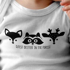 a baby wearing a t - shirt that says cutest critter in the forest