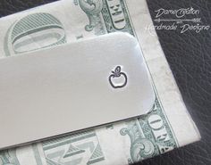 So many choices with this money clip from the design to customizing this piece with a message on the Front, Back or Both sides. I will try my best to accommodate what you want written the way you would like. Please let me know if you want the backside stamped vertically or horizontally, if no specifics are given I will stamp it the way I see best and be creative! LISTING INCLUDES ♦ One 2 1/2 inches long and 1-inch wide when bent, 16-gauge 3003 aluminum, 18-gauge copper, OR 18-gauge brass that ha Diy Money Clip, Silver Rectangular Card Holder For Gift, Silver Rectangular Wallet, Silver Rectangular Card Holder Gift, Money Clips For Men, Engraved Money Clip, Leather Money Clip Wallet, Silver Money Clip, Leather Money Clips