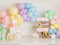 an ice cream cart is surrounded by balloons and confetti