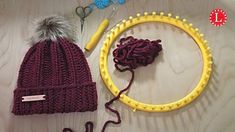 a knitted beanie hat next to a pair of knitting needles and yarn ball