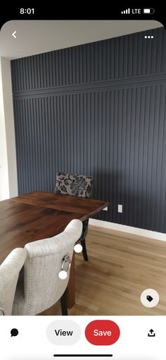 an iphone photo of a dining room table and chairs with the same color wallpaper