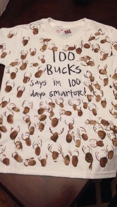 a t - shirt that says 100 bucks, says i'm 100 days smarter