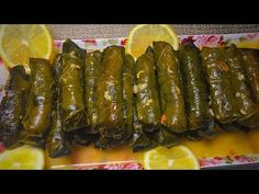 stuffed grape leaves with lemon wedges on a plate