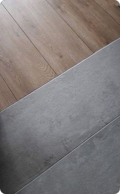 a black and white cat laying on top of a wooden floor