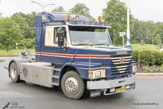 a large blue truck is parked on the street