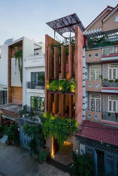 an apartment building with plants growing on the balconies