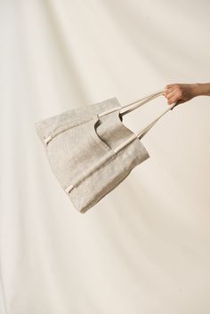 "🌿 DETAILS 🌿 ✳ Pockets on both sides ✳ One main compartment ✳ Bag unlined ✳ Cotton rope handles (black or off white) 🌿 DESCRIPTION 🌿 This linen bag is a trusted everyday companion. Designed with a relaxed shape and a generous size that make it a versatile choice through the seasons - whether that's for trips to the store, work or the beach. It's easy to carry, thanks to the pair of comfortable chunky rope handles and spacious enough for carrying all your essentials. Take this bag with you for all your everyday outings.  Also, by having versatile pieces like this in your closet will help you to dress more consciously and adopt 'the less is more' philosophy. 🔸Please note that due to the many variations in monitors and browsers, actual colors may vary.🔸 🔸Different colors are available. Jute Bag Photography, Tod Bag, Linen Accessories, Linen Products, Compartment Bag, Linen Bags, Retail Bag, Linen Tote Bag, Cotton Handbag